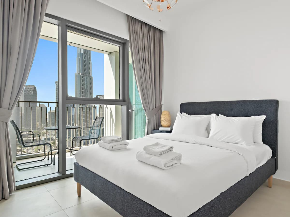 Bedroom with balcony and Burj Khalifa view in one of our 2-bedroom apartments at Downtown Views II